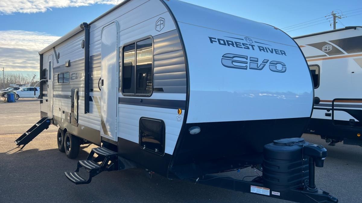 Front of a Forest River EVO travel trailer, showing the tongue jack and hitch coupler